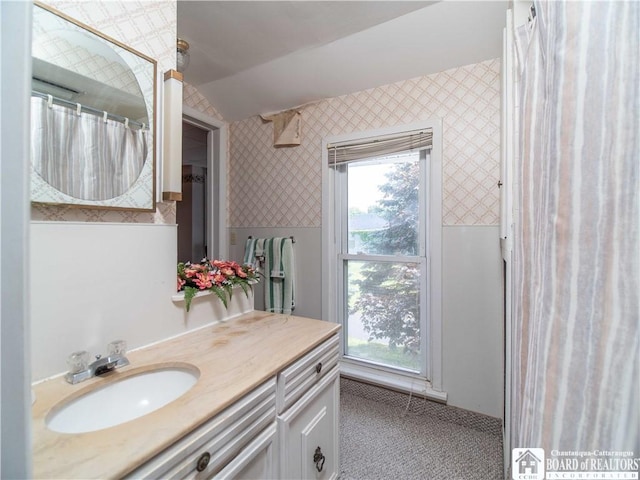 12 Central Ave, Portland, NY 14716 - bathroom featuring wallpapered walls, vaulted ceiling, and vanity
