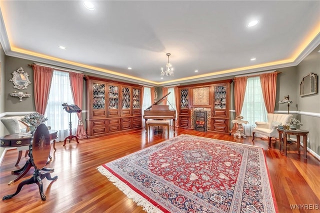 9555 The Maples, Clarence, NY 14031 - sitting room with ornamental molding, a chandelier, and wood finished floors