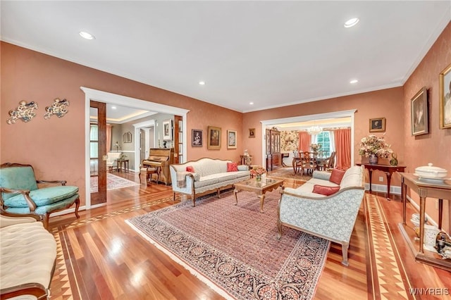 9555 The Maples, Clarence, NY 14031 - living area featuring light wood-type flooring, crown molding, recessed lighting, and a chandelier