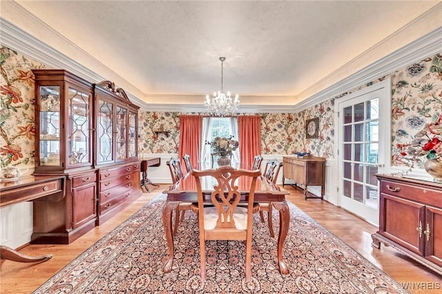 9555 The Maples, Clarence, NY 14031 - dining room with wallpapered walls, a chandelier, wainscoting, ornamental molding, and a tray ceiling