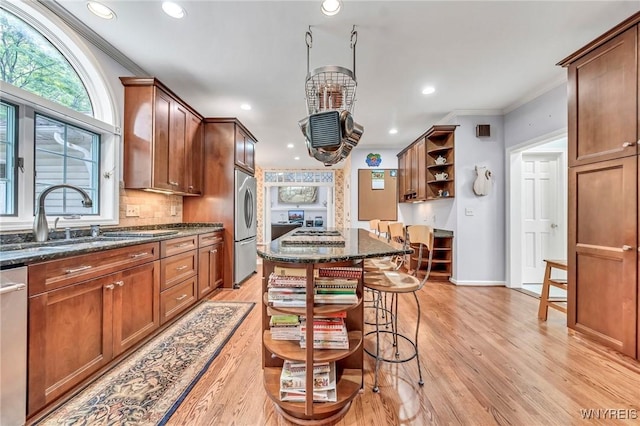 9555 The Maples, Clarence, NY 14031 - kitchen with stainless steel fridge, crown molding, open shelves, light wood-style floors, and dark stone counters