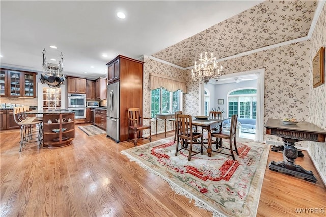 9555 The Maples, Clarence, NY 14031 - dining space featuring wallpapered walls, a chandelier, ornamental molding, light wood finished floors, and recessed lighting