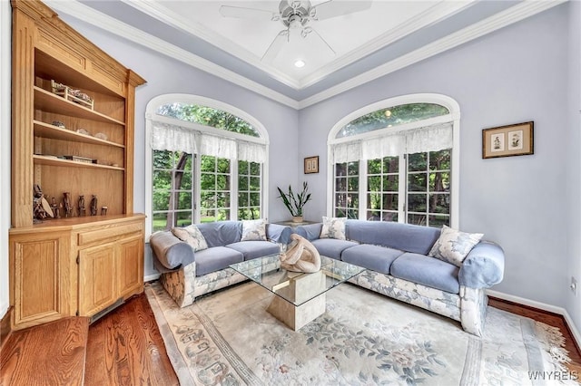 9555 The Maples, Clarence, NY 14031 - living area featuring wood finished floors, healthy amount of natural light, ceiling fan, and ornamental molding
