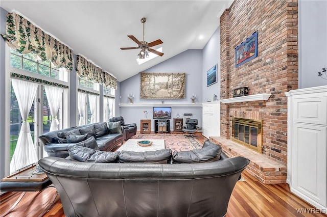 9555 The Maples, Clarence, NY 14031 - living area with a ceiling fan, a fireplace, wood finished floors, and high vaulted ceiling