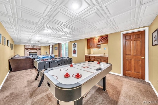 9555 The Maples, Clarence, NY 14031 - recreation room with light carpet, a fireplace, an ornate ceiling, and bar with sink