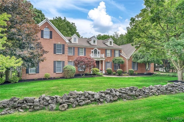 9555 The Maples, Clarence, NY 14031 - colonial-style house with brick siding and a front lawn