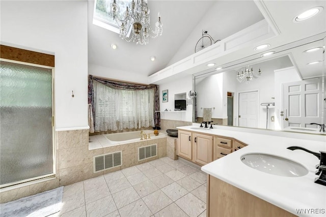 9555 The Maples, Clarence, NY 14031 - full bathroom with a chandelier, double vanity, a bath, high vaulted ceiling, and recessed lighting