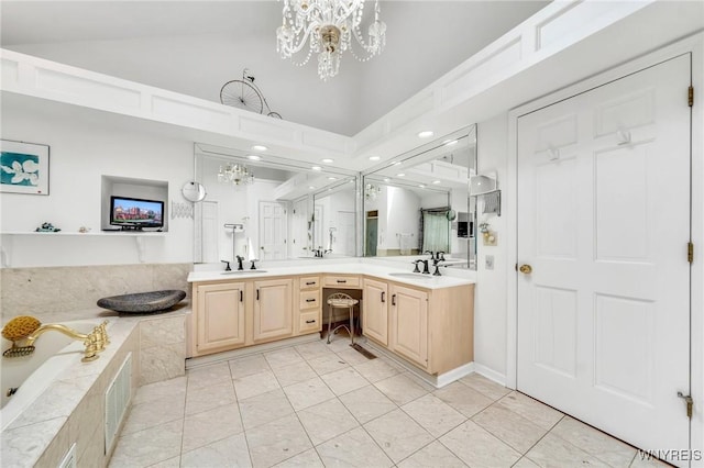 9555 The Maples, Clarence, NY 14031 - full bath featuring double vanity, a chandelier, tile patterned flooring, a garden tub, and lofted ceiling