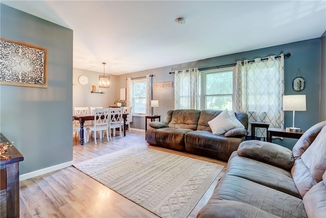 85 Campfire Rd N, Henrietta, NY 14467 - living area with light wood finished floors and a chandelier
