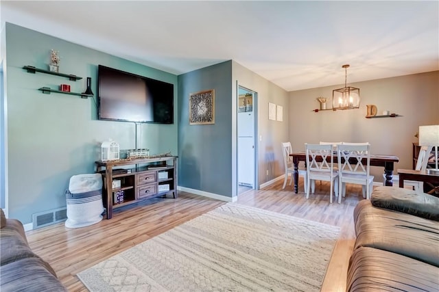 85 Campfire Rd N, Henrietta, NY 14467 - living room featuring a chandelier and wood finished floors
