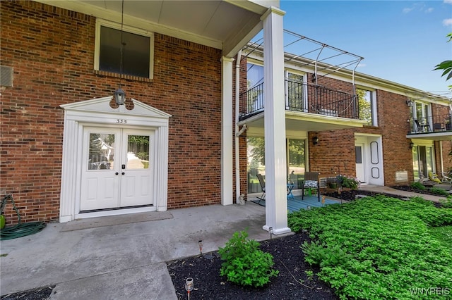 335 S Cayuga Rd Unit B, Amherst, NY 14221 - property entrance with a balcony and brick siding