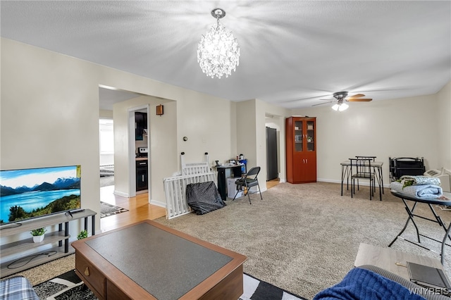 335 S Cayuga Rd Unit B, Amherst, NY 14221 - living area featuring a ceiling fan, a chandelier, and light carpet