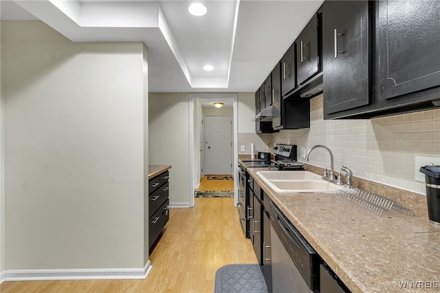 335 S Cayuga Rd Unit B, Amherst, NY 14221 - kitchen featuring appliances with stainless steel finishes, dark cabinets, light wood-type flooring, backsplash, and recessed lighting