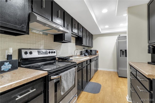 335 S Cayuga Rd Unit B, Amherst, NY 14221 - kitchen with stainless steel appliances, extractor fan, dark cabinets, tasteful backsplash, and recessed lighting