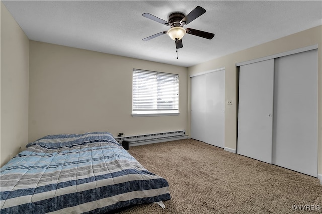 335 S Cayuga Rd Unit B, Amherst, NY 14221 - carpeted bedroom featuring baseboard heating, multiple closets, ceiling fan, and a textured ceiling