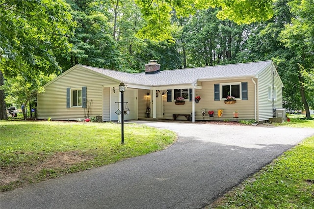 28 Crossfield Rd, Perinton, NY 14450 - ranch-style house with driveway, a front yard, a chimney, and view of scattered trees
