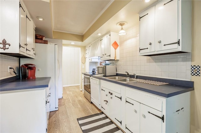 28 Crossfield Rd, Perinton, NY 14450 - kitchen with dark countertops, backsplash, white cabinetry, ornamental molding, and light wood-type flooring