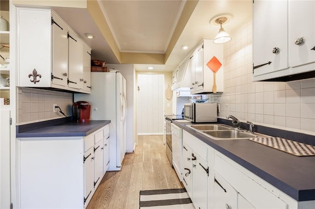 28 Crossfield Rd, Perinton, NY 14450 - kitchen with dark countertops, stainless steel microwave, backsplash, light wood-type flooring, and white cabinetry