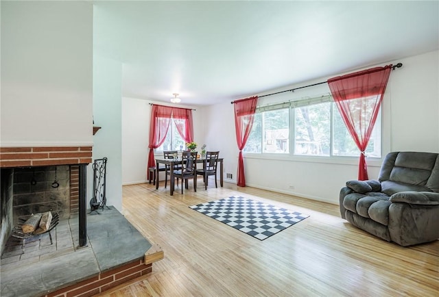 28 Crossfield Rd, Perinton, NY 14450 - living room with a brick fireplace and wood finished floors