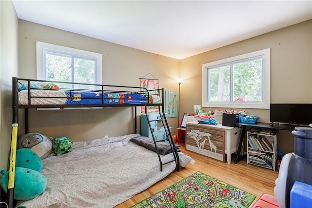 28 Crossfield Rd, Perinton, NY 14450 - bedroom featuring multiple windows and wood finished floors