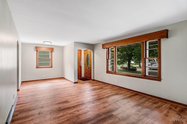 44 Deuro Dr, Niagara Falls, NY 14304 - spare room with arched walkways and wood finished floors