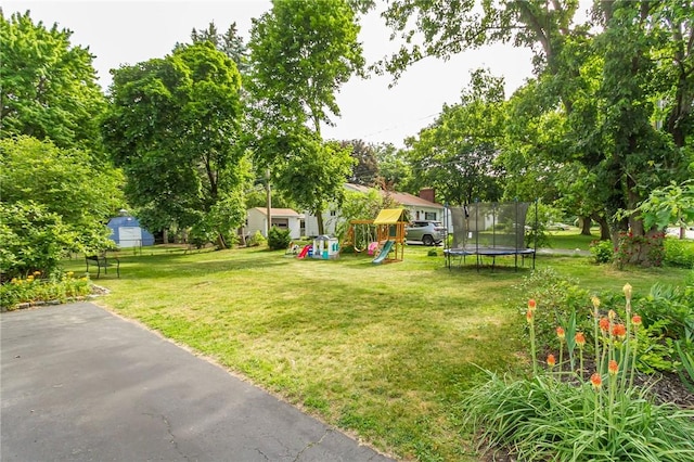 264 Harvest Dr, Greece, NY 14626 - view of green lawn featuring a trampoline and a playground