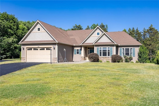 996 Summer Creek Ln, Webster, NY 14580 - view of front of home featuring asphalt driveway, a garage, a front lawn, stone siding, and a shingled roof