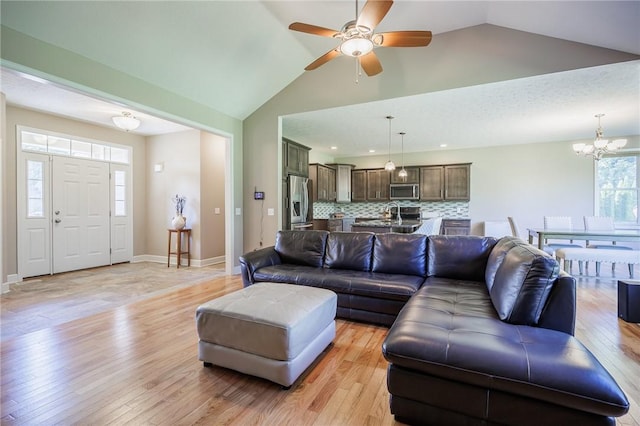 996 Summer Creek Ln, Webster, NY 14580 - living room featuring a chandelier, light wood-style floors, a ceiling fan, and high vaulted ceiling