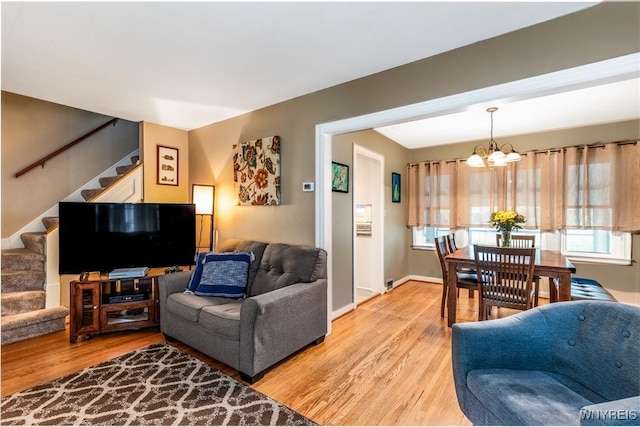 29 Charlestown Rd, Amherst, NY 14226 - living area with stairs, a chandelier, and light wood-style flooring