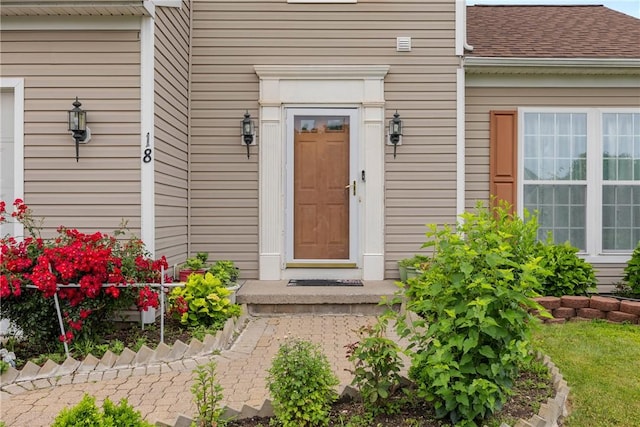 18 Butterfly Ln, Henrietta, NY 14586 - property entrance featuring a shingled roof