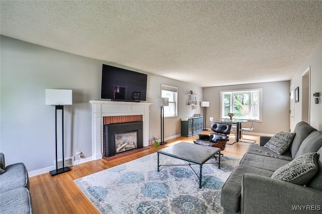 170 Sargent Dr, Amherst, NY 14226 - living area featuring a textured ceiling, wood finished floors, and a brick fireplace