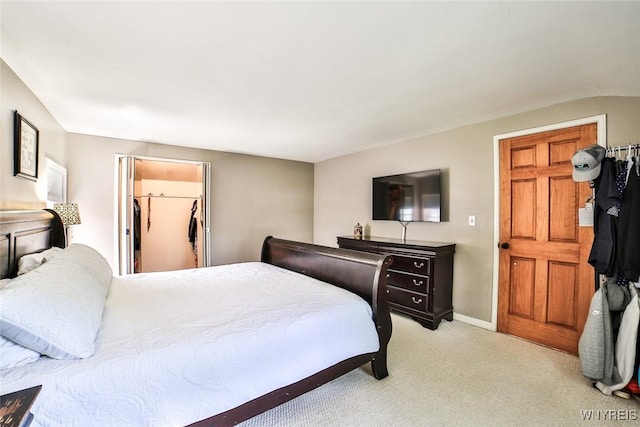 170 Sargent Dr, Amherst, NY 14226 - bedroom with light carpet, a walk in closet, vaulted ceiling, and a closet