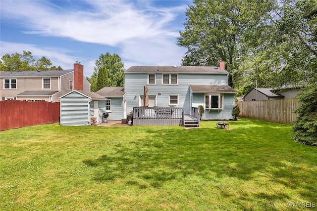170 Sargent Dr, Amherst, NY 14226 - rear view of property with a fenced backyard, a deck, a fire pit, and a chimney