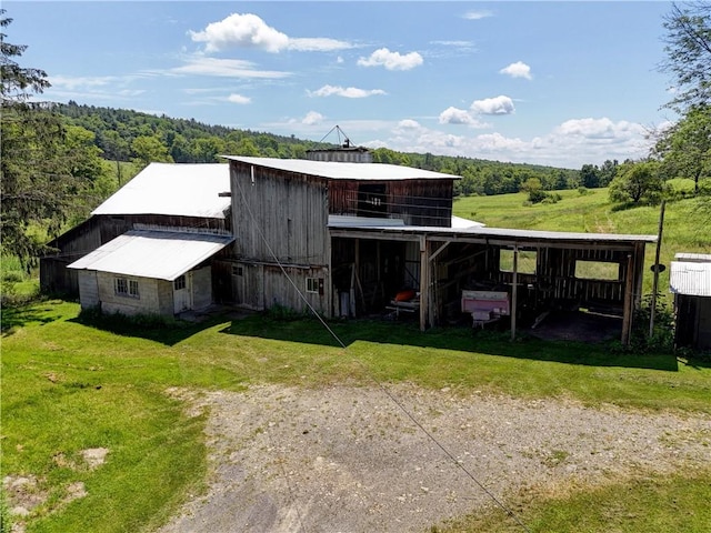 212 Hill Rd, Danby, NY 14001 - view of outdoor structure with dirt driveway, a forest view, and a carport
