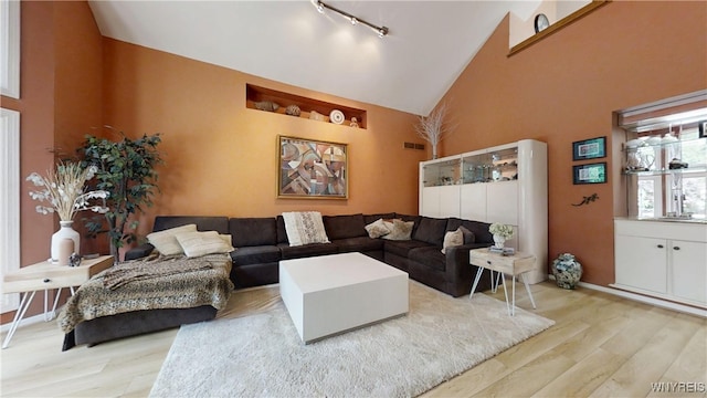 6097 Wellesley Cmn, Clarence, NY 14051 - living area featuring high vaulted ceiling, wood finished floors, and track lighting
