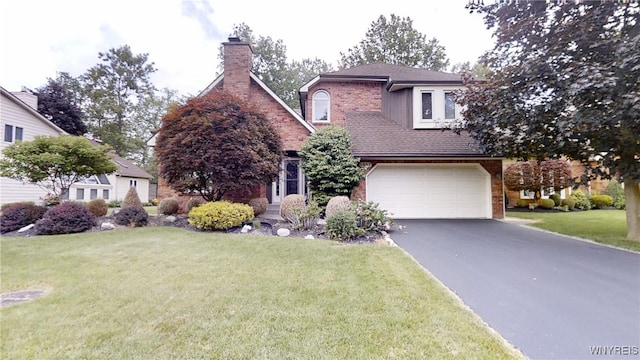 6097 Wellesley Cmn, Clarence, NY 14051 - view of front of property with asphalt driveway, a garage, a front lawn, a chimney, and brick siding