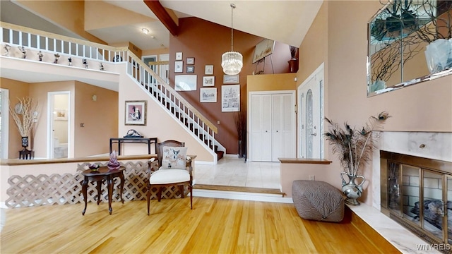 6097 Wellesley Cmn, Clarence, NY 14051 - entrance foyer with high vaulted ceiling, stairway, wood finished floors, and a fireplace with flush hearth