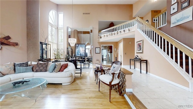 6097 Wellesley Cmn, Clarence, NY 14051 - living room featuring a towering ceiling, stairs, and wood finished floors