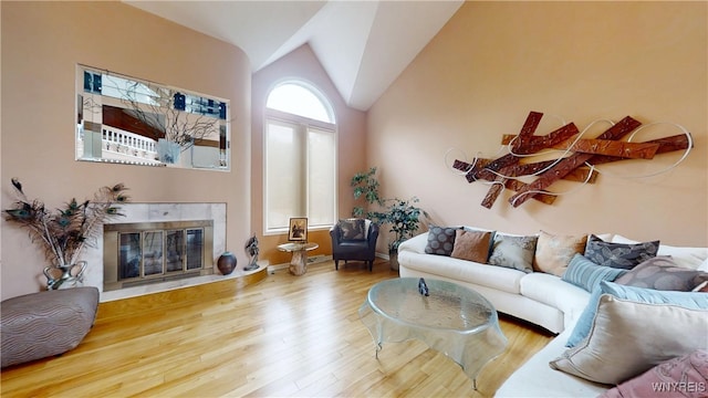 6097 Wellesley Cmn, Clarence, NY 14051 - living room with a tile fireplace, wood finished floors, and lofted ceiling