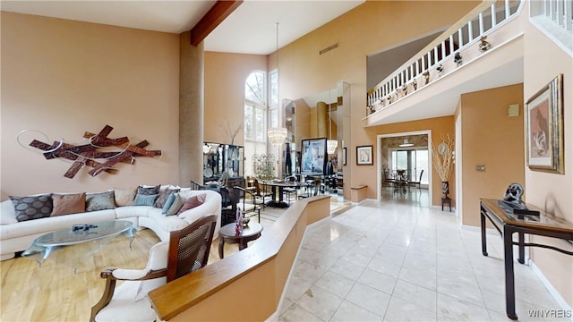 6097 Wellesley Cmn, Clarence, NY 14051 - living room with a towering ceiling, plenty of natural light, light tile patterned floors, and beam ceiling