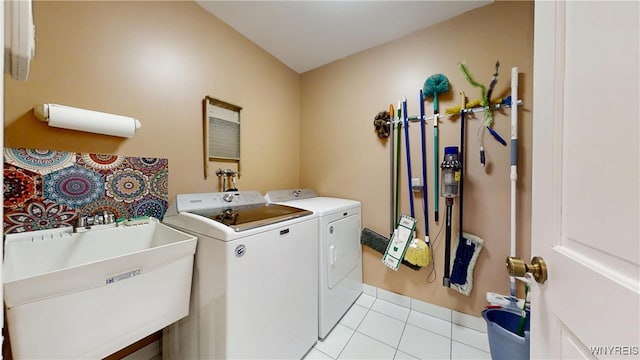 6097 Wellesley Cmn, Clarence, NY 14051 - laundry room featuring washer and dryer and light tile patterned flooring