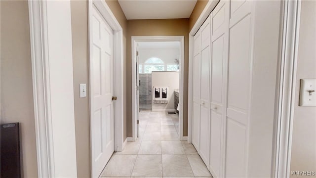 6097 Wellesley Cmn, Clarence, NY 14051 - hall featuring light tile patterned floors and baseboards