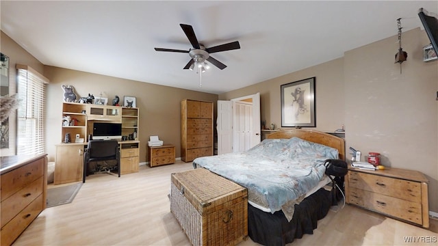 6097 Wellesley Cmn, Clarence, NY 14051 - bedroom featuring an office area, a ceiling fan, and light wood-style flooring