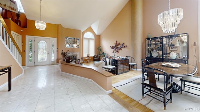 6097 Wellesley Cmn, Clarence, NY 14051 - tiled entrance foyer featuring a chandelier, high vaulted ceiling, and stairs
