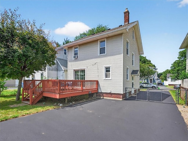 55 Morville Dr, Rochester, NY 14615 - rear view of property featuring a deck, a gate, and a chimney