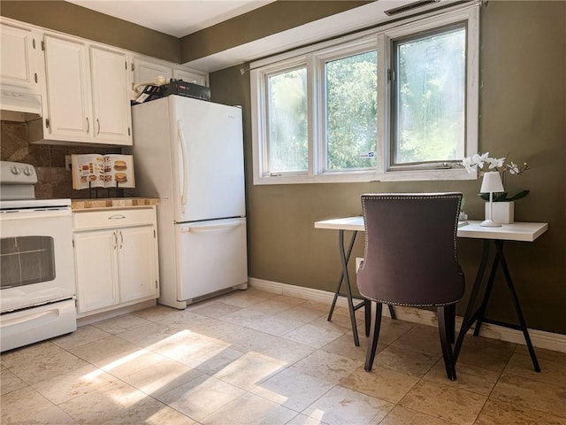124 Adams St, Rochester, NY 14608 - kitchen with white appliances, under cabinet range hood, white cabinetry, and backsplash