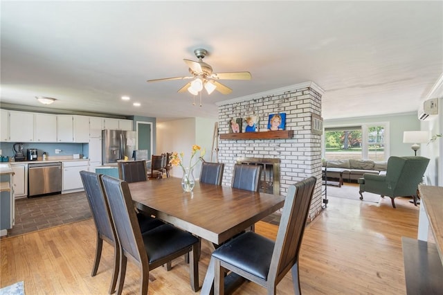 1015 Wayneport Rd, Macedon, NY 14502 - dining area featuring ceiling fan, light wood finished floors, and a brick fireplace