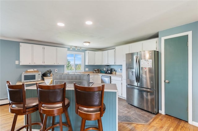 1015 Wayneport Rd, Macedon, NY 14502 - kitchen with stainless steel appliances, light countertops, white cabinets, a center island, and recessed lighting