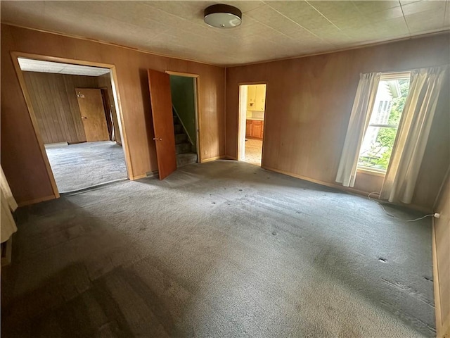 22 N Main St, Elba, NY 14058 - empty room featuring stairs, carpet, and wooden walls