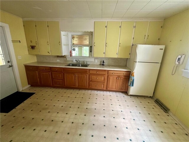 22 N Main St, Elba, NY 14058 - kitchen featuring freestanding refrigerator, light countertops, light floors, and brown cabinetry